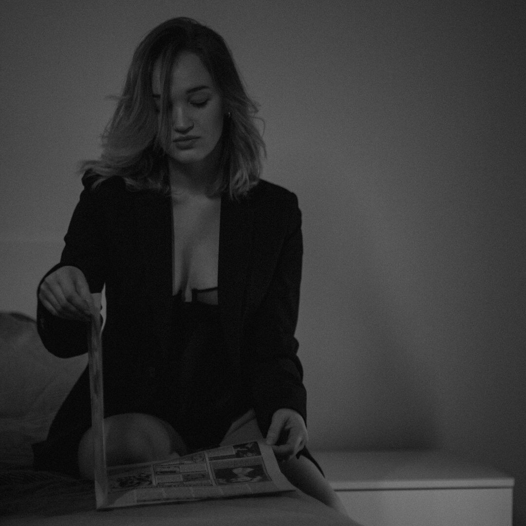 Croatian woman editor reviewing archive photographs at her desk