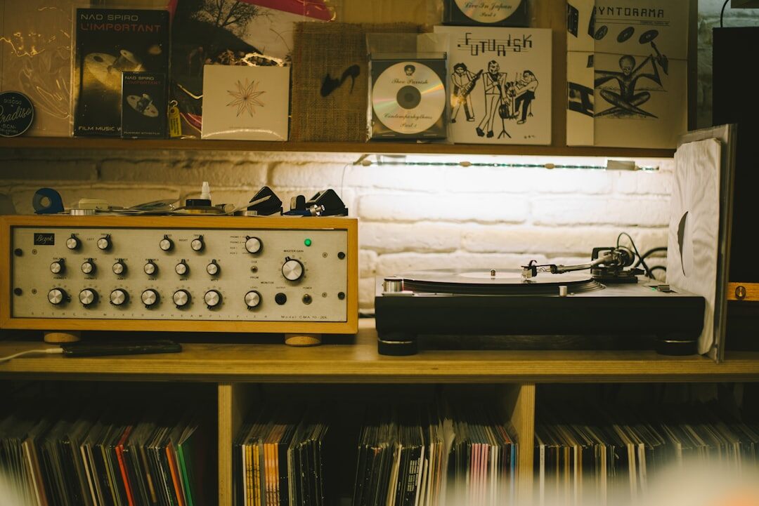 Vintage home recording studio with a mixing console and vinyl records
