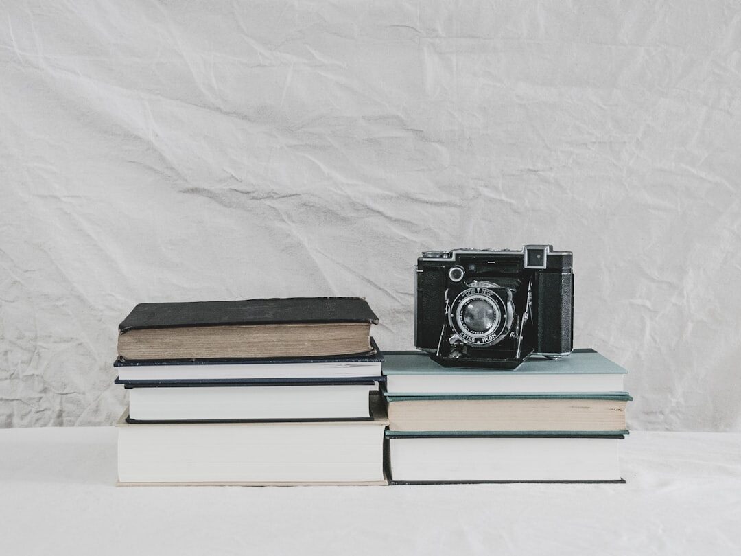 Stack of vintage magazines and photographs on a wooden table